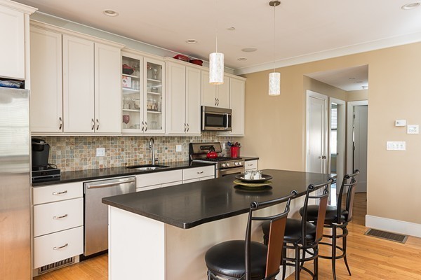 1506 Columbia Road, Unit 1 Boston, MA 02127 - Photo 13 of 24 a kitchen with a stove a sink and a refrigerator