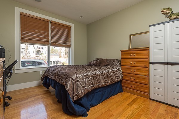 1506 Columbia Road, Unit 1 Boston, MA 02127 - Photo 18 of 24 a bedroom with a bed next to a window