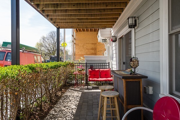 1506 Columbia Road, Unit 1 Boston, MA 02127 - Photo 7 of 24 a view of a balcony with chairs and a stove