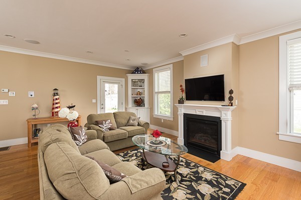 1506 Columbia Road, Unit 1 Boston, MA 02127 - Photo 9 of 24 a living room with furniture a fireplace and a flat screen tv