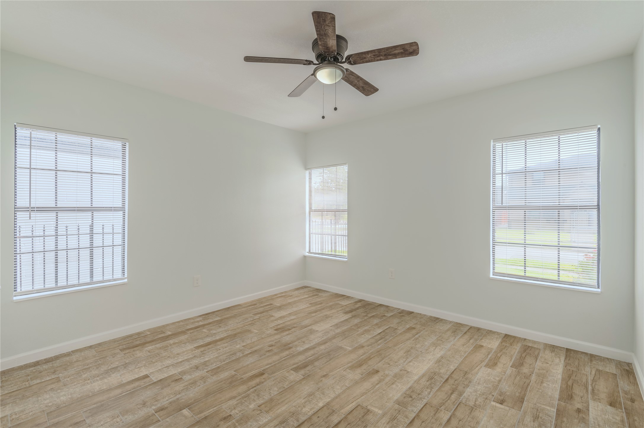 2319 Rosewood Street, Unit A Houston, TX 77004 - Photo 13 of 15 an empty room with window and ceiling fan