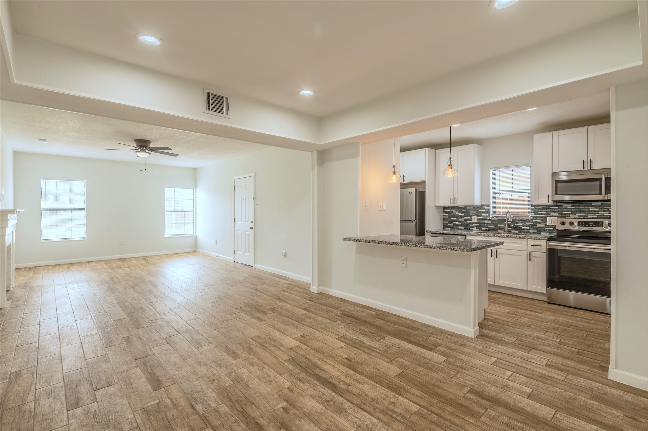 2319 Rosewood Street, Unit A Houston, TX 77004 - Photo 2 of 15 a view of a kitchen with a sink and dishwasher a stove top oven with wooden floor