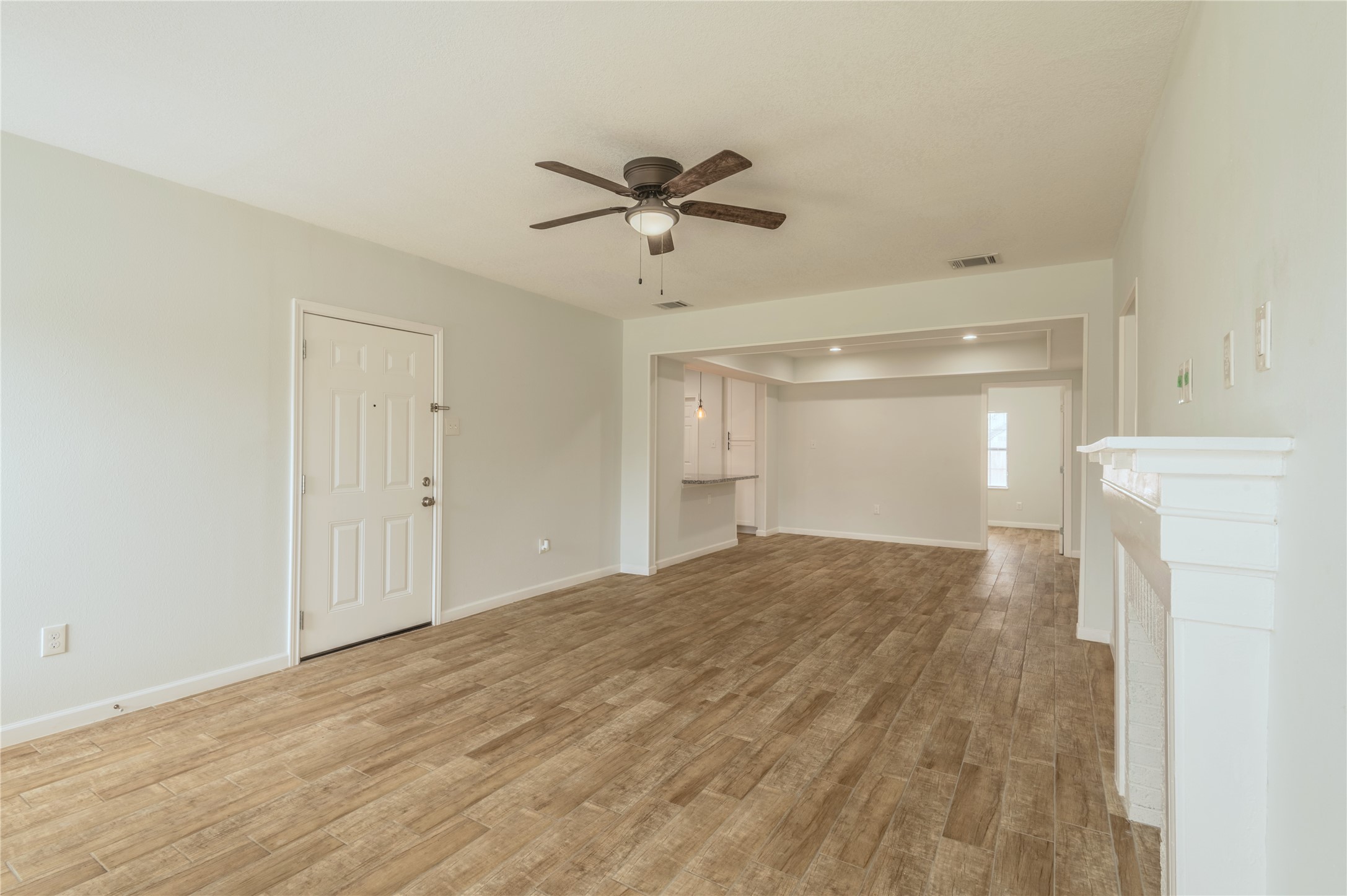 2319 Rosewood Street, Unit A Houston, TX 77004 - Photo 3 of 15 a view of a livingroom with a chandelier fan and wooden floor