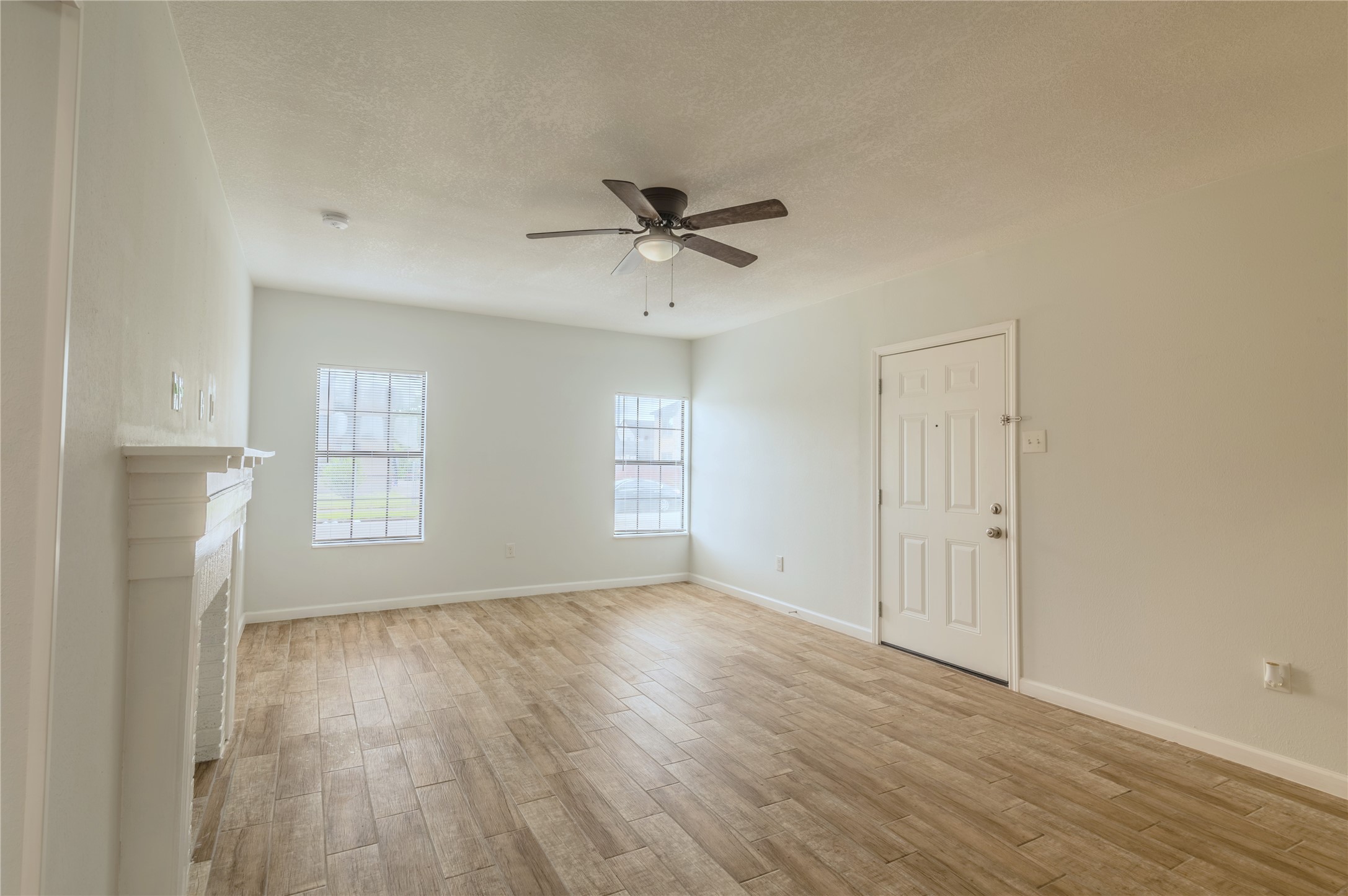 2319 Rosewood Street, Unit A Houston, TX 77004 - Photo 5 of 15 an empty room with wooden floor and windows