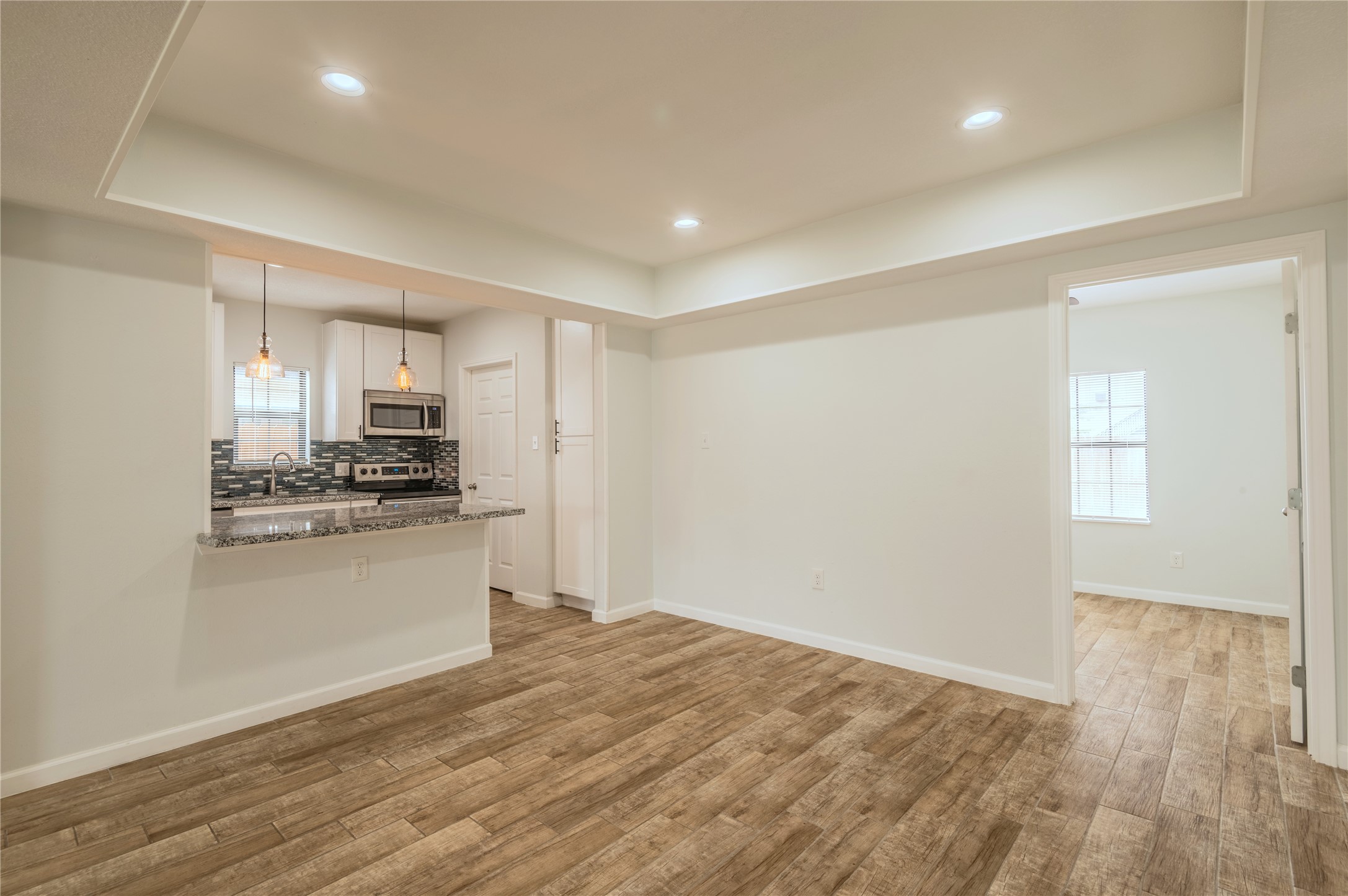 2319 Rosewood Street, Unit A Houston, TX 77004 - Photo 6 of 15 a kitchen with stainless steel appliances granite countertop a refrigerator and a stove top oven