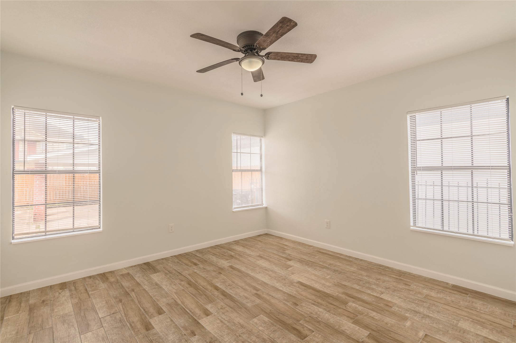 2319 Rosewood Street, Unit A Houston, TX 77004 - Photo 8 of 15 a view of empty room with wooden floor and fan