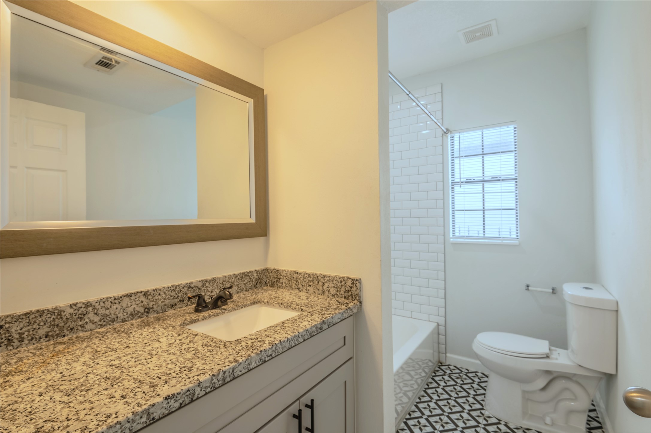 2319 Rosewood Street, Unit A Houston, TX 77004 - Photo 10 of 15 a bathroom with a granite countertop sink toilet and shower