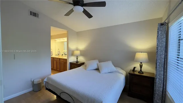 a bedroom with a bed and a lamp