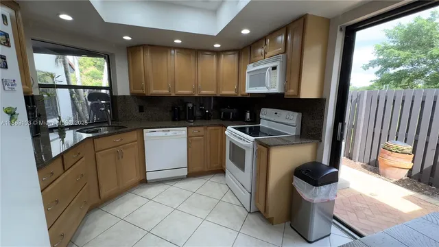 a kitchen with a sink cabinets and window