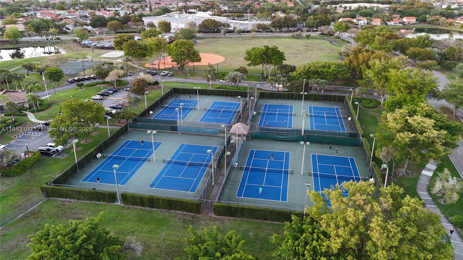 15205 Southwest 45th Terrace, Unit 45E Miami, FL 33185 - Photo 8 of 9 an aerial view of a house with a yard and lake view