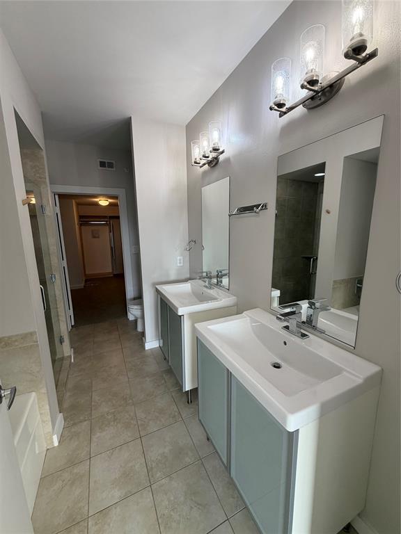 4040 North Hall Street, Unit 309 Dallas, TX 75219 - Photo 11 of 18 a bathroom with a sink a vanity and a mirror