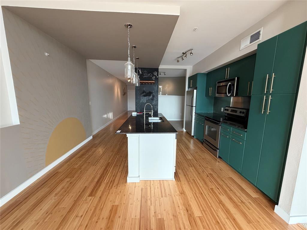 4040 North Hall Street, Unit 309 Dallas, TX 75219 - Photo 12 of 18 a view of a hallway with wooden floor