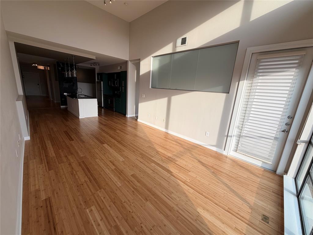 4040 North Hall Street, Unit 309 Dallas, TX 75219 - Photo 13 of 18 a view of hallway with wooden floor