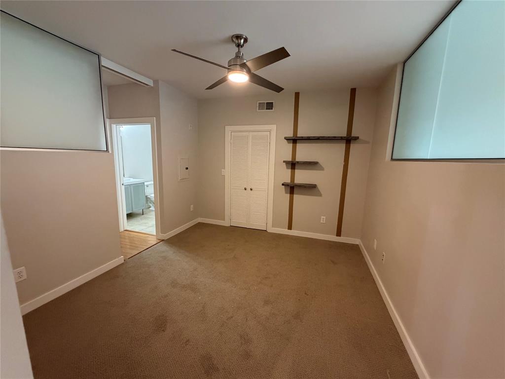 4040 North Hall Street, Unit 309 Dallas, TX 75219 - Photo 16 of 18 an empty room with a empty space and windows