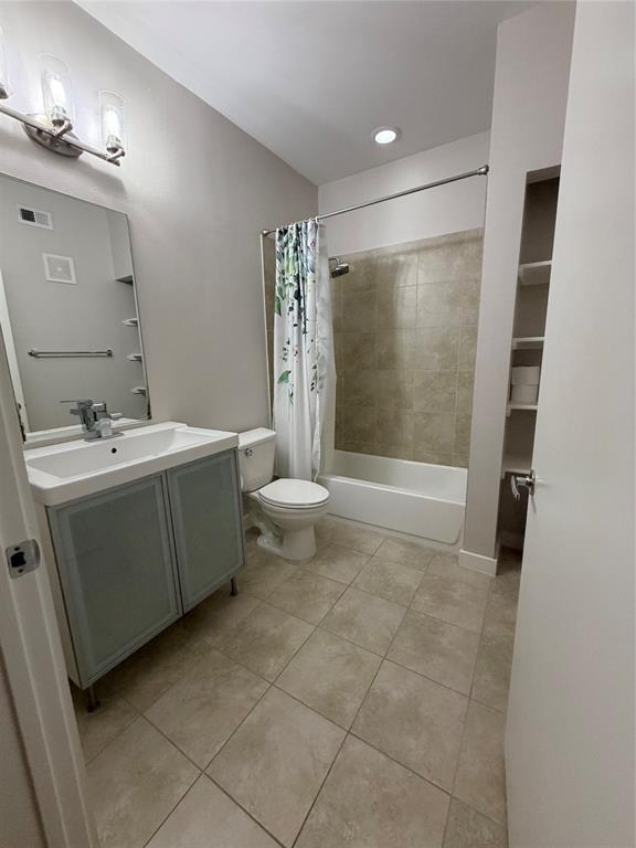 4040 North Hall Street, Unit 309 Dallas, TX 75219 - Photo 17 of 18 a bathroom with a sink a toilet and shower