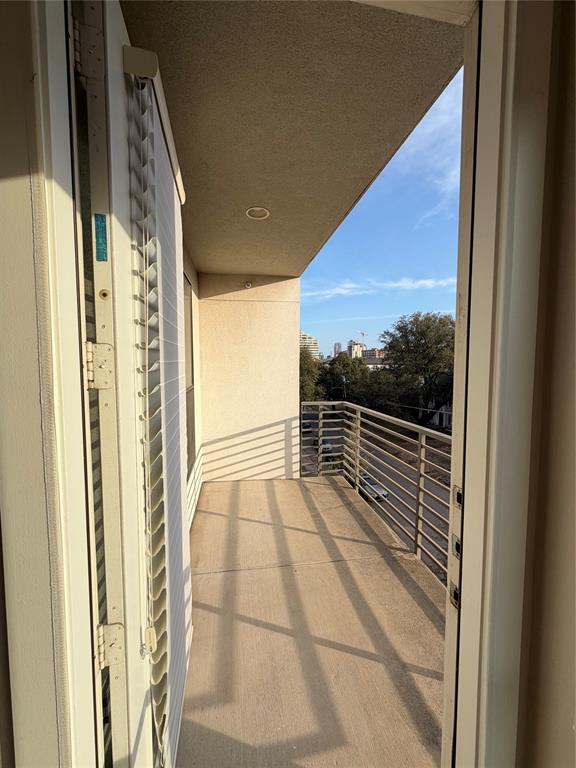 4040 North Hall Street, Unit 309 Dallas, TX 75219 - Photo 18 of 18 a view of balcony with floor to ceiling window and wooden floor