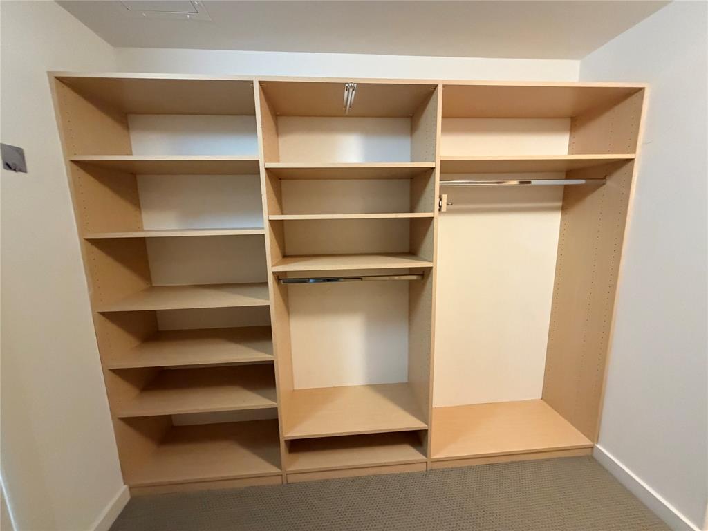 4040 North Hall Street, Unit 309 Dallas, TX 75219 - Photo 5 of 18 a view of walk in closet with empty racks