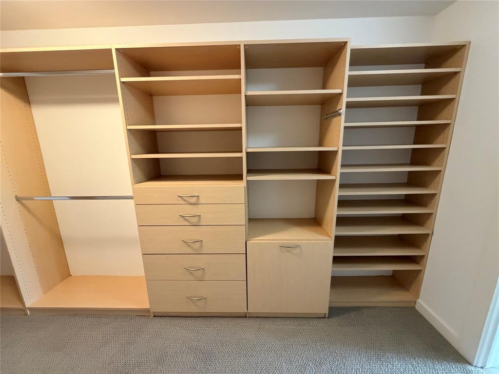 4040 North Hall Street, Unit 309 Dallas, TX 75219 - Photo 6 of 18 a view of an empty room with empty racks