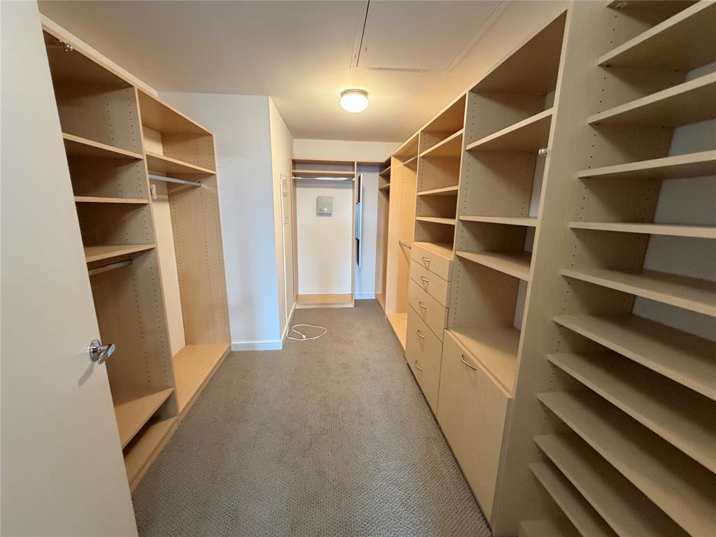 4040 North Hall Street, Unit 309 Dallas, TX 75219 - Photo 8 of 18 a view of walk in closet with empty racks