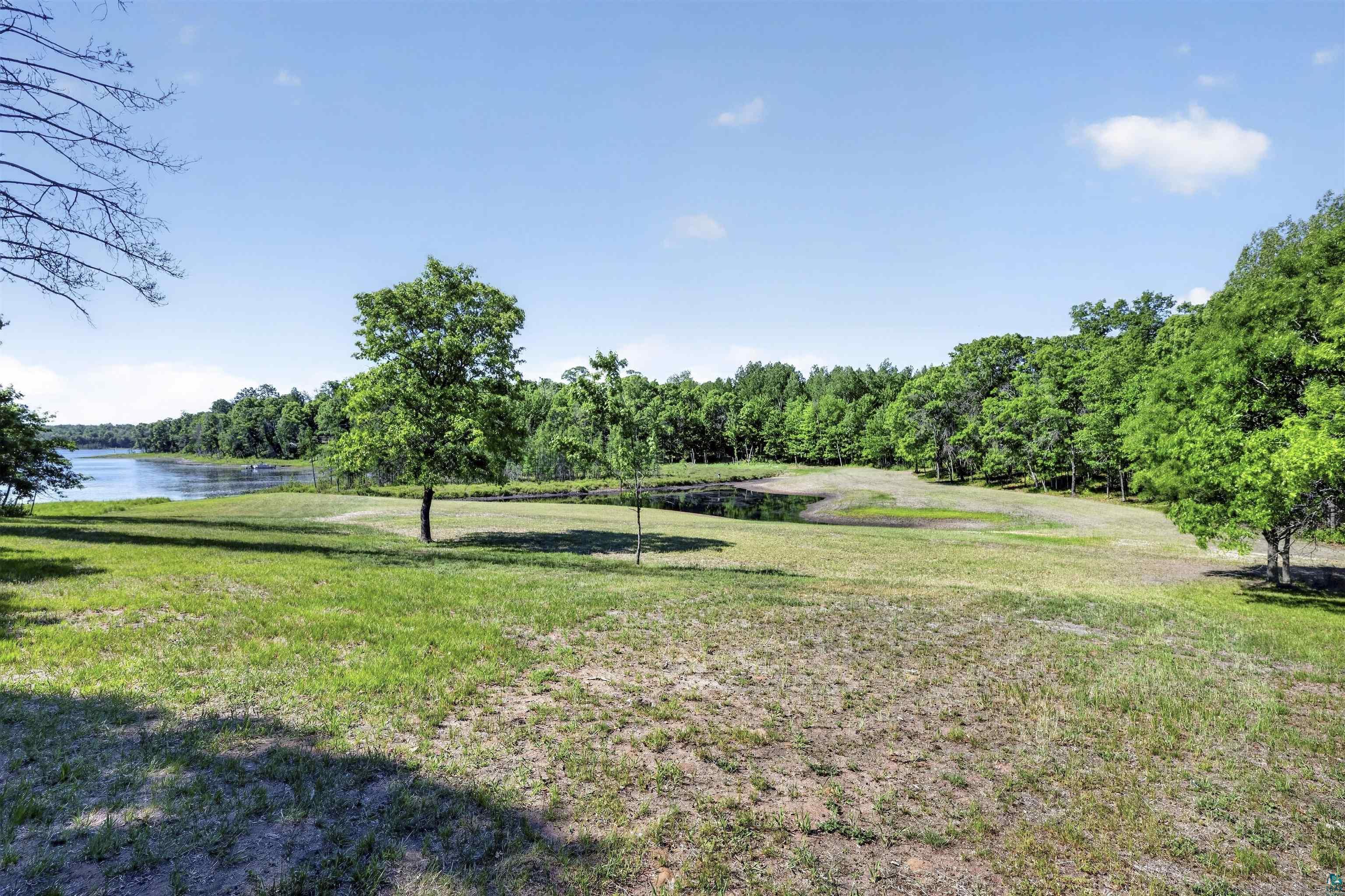 11702 East Mail Road Gordon, WI 54838 - Photo 15 of 60 Expansive natural landscape featuring a prominent body of water, mature trees, and open grassy areas