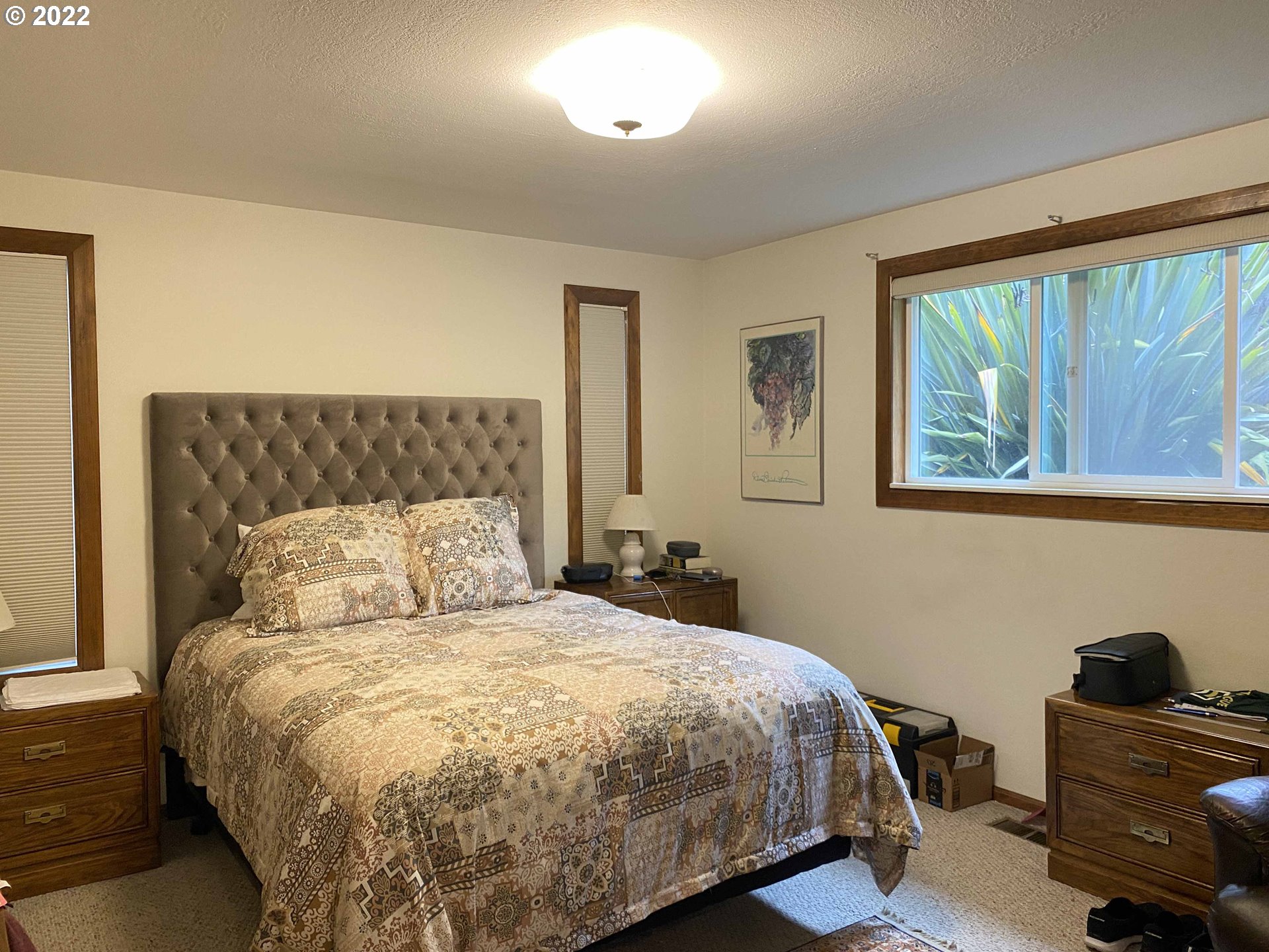 2222 11th Street Florence, OR 97439 - Photo 18 of 32 a bed sitting in a bedroom next to a window