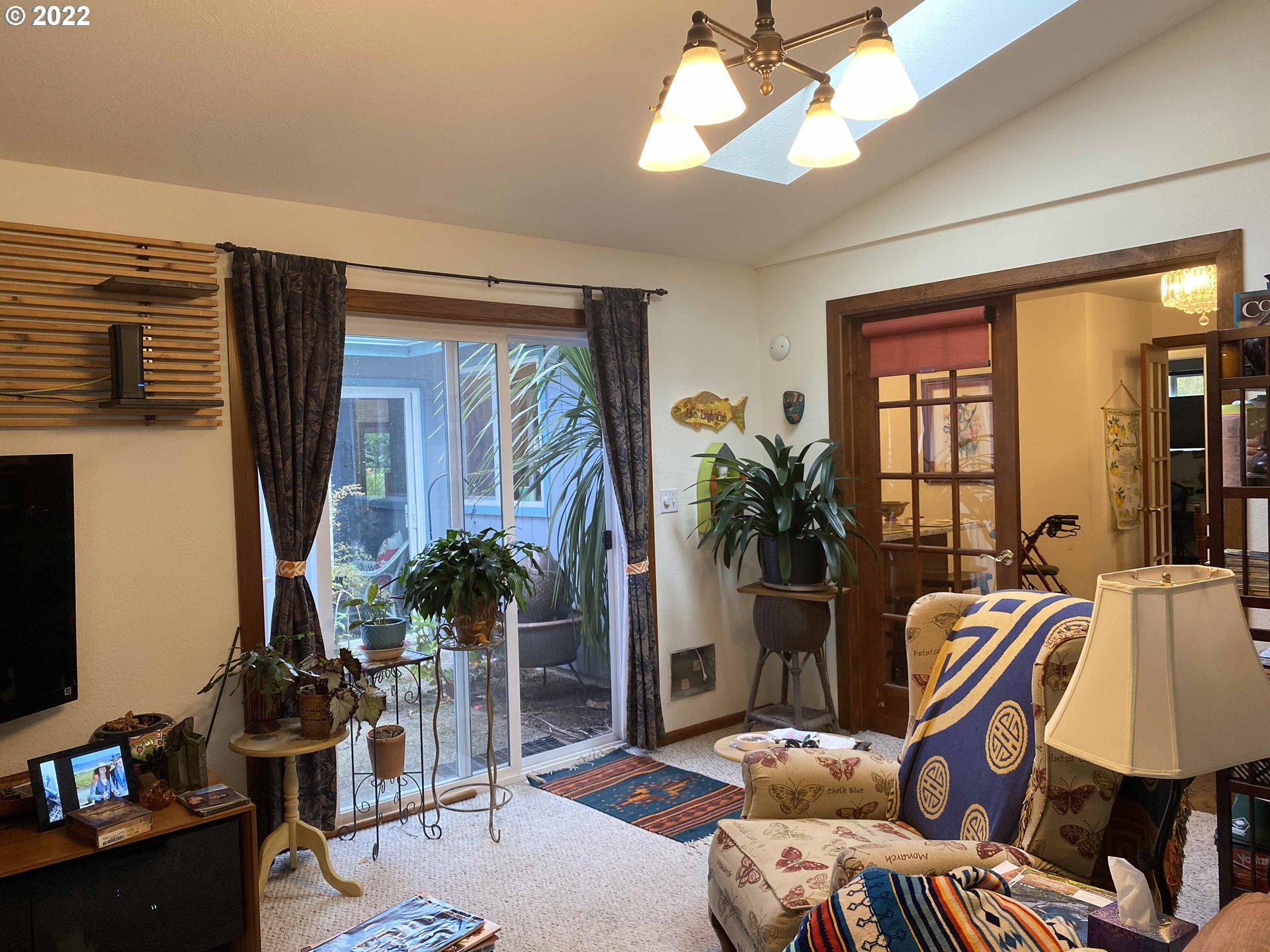 2222 11th Street Florence, OR 97439 - Photo 24 of 32 a living room with furniture ceiling fan and a window