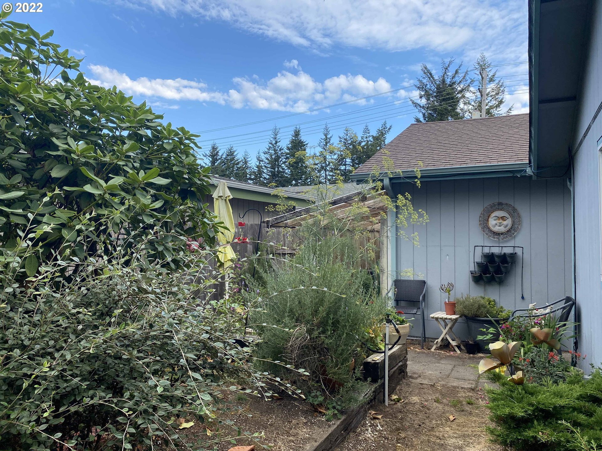 2222 11th Street Florence, OR 97439 - Photo 29 of 32 a backyard of a house with table and chairs