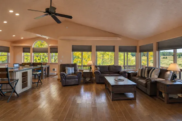 a living room with furniture and large windows