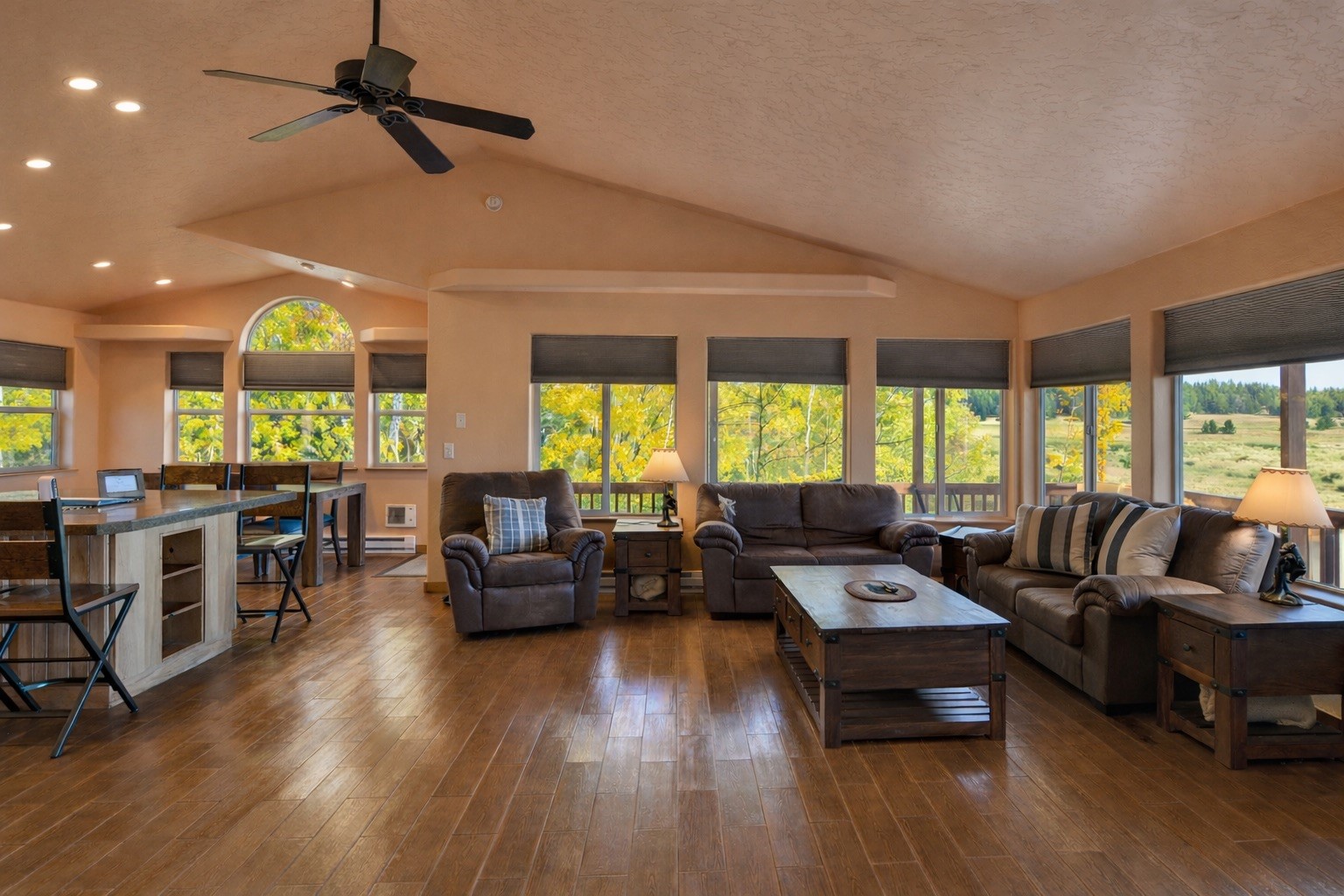 a living room with furniture and large windows