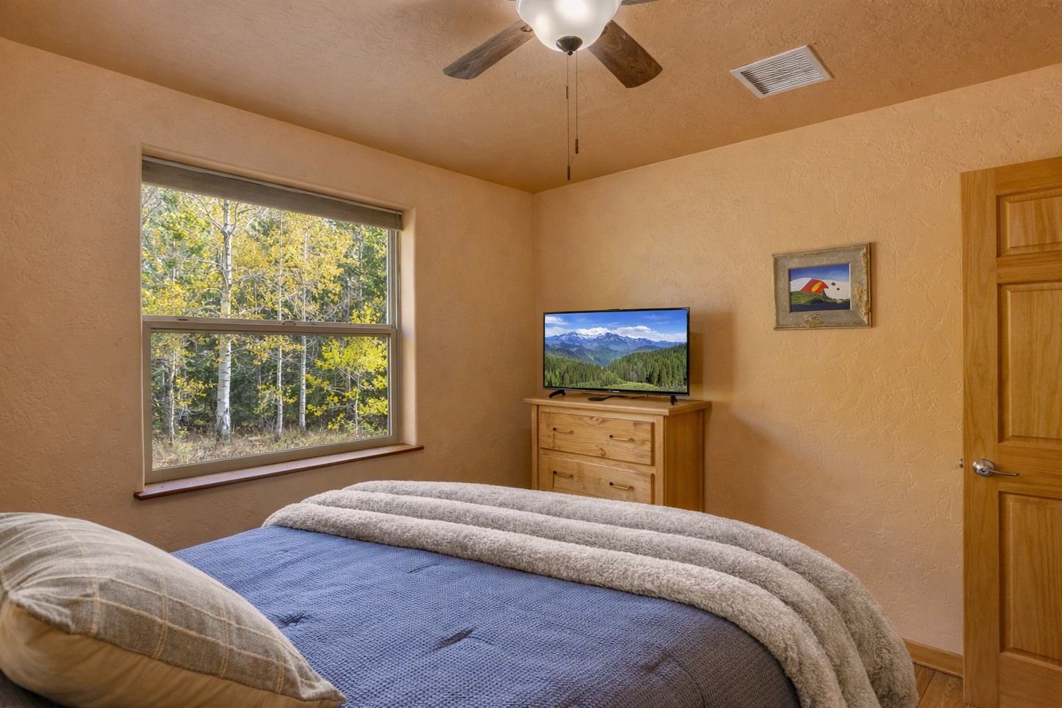 155 Lamb Mountain Road Fairplay, CO 80440 - Photo 17 of 48 a bedroom with a bed and a flat screen tv