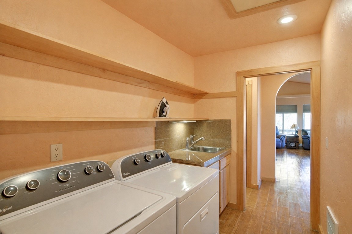 155 Lamb Mountain Road Fairplay, CO 80440 - Photo 22 of 48 Washroom featuring arched walkways, separate washer and dryer, recessed lighting, and light wood-style flooring