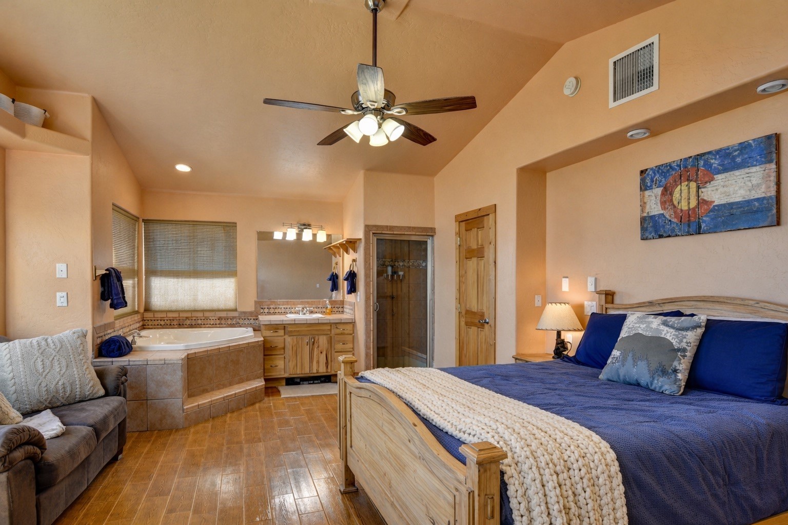 155 Lamb Mountain Road Fairplay, CO 80440 - Photo 24 of 48 a spacious bedroom with a large bed a chandelier and a window