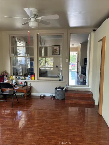 a living room with furniture window and wooden floor