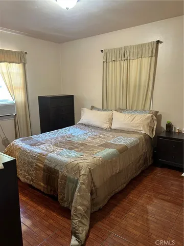 a bed sitting in a bedroom next to a window