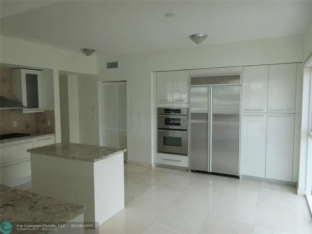 a kitchen with granite countertop a sink and a stove