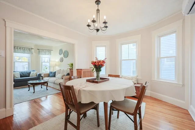 a view of a dining room with furniture wooden floor and a chandelier