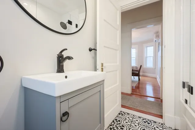 a bathroom with a sink a toilet and a mirror