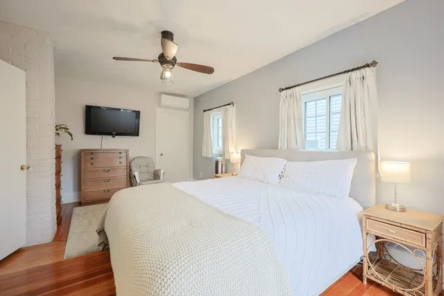 a bedroom with a bed and a flat tv screen