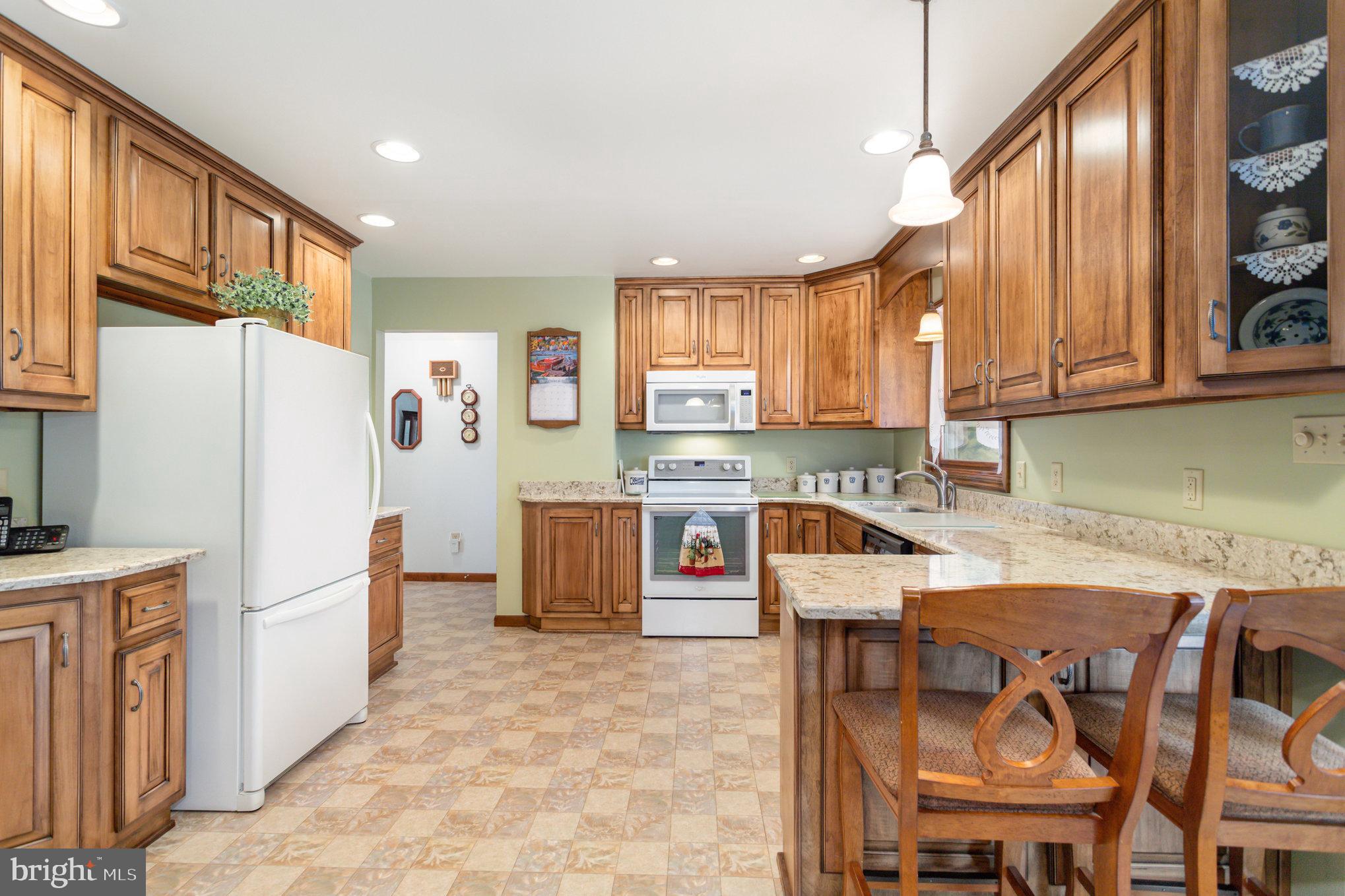 29 Robin Circle Halifax, PA 17032 - Photo 12 of 35 a kitchen with stainless steel appliances granite countertop a refrigerator sink and wooden cabinets