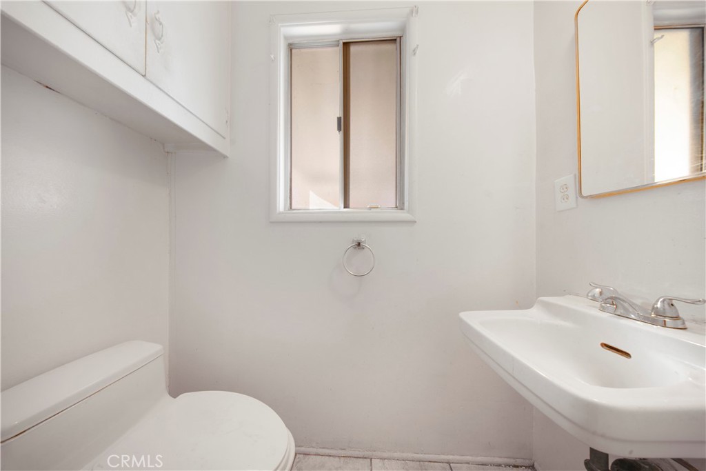 10531 Mulhall Street El Monte, CA 91731 - Photo 8 of 13 a bathroom with a sink a toilet and mirror