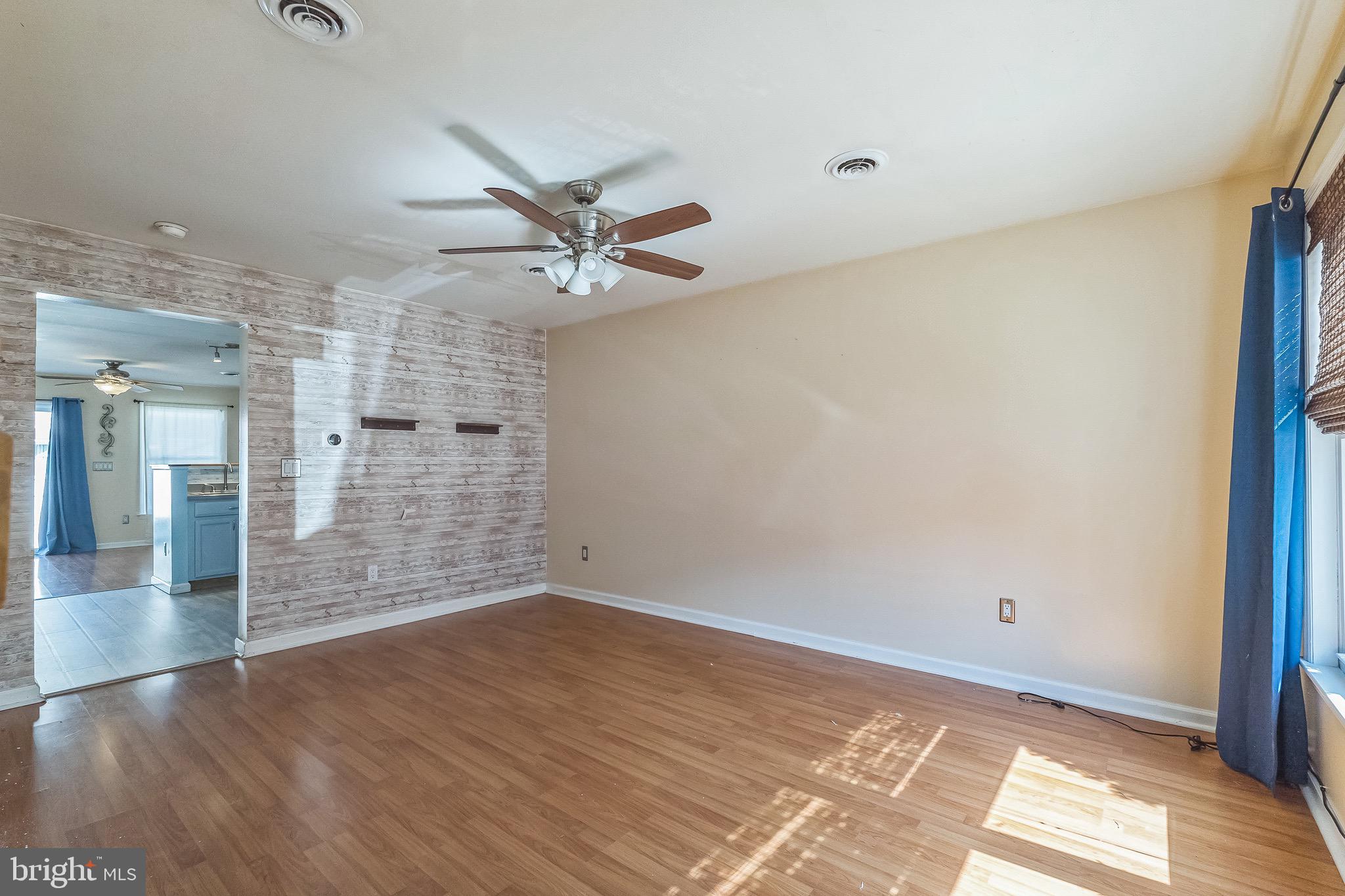 3566 Edgemont Street Philadelphia, PA 19134 - Photo 5 of 25 a view of an empty room with wooden floor and a window