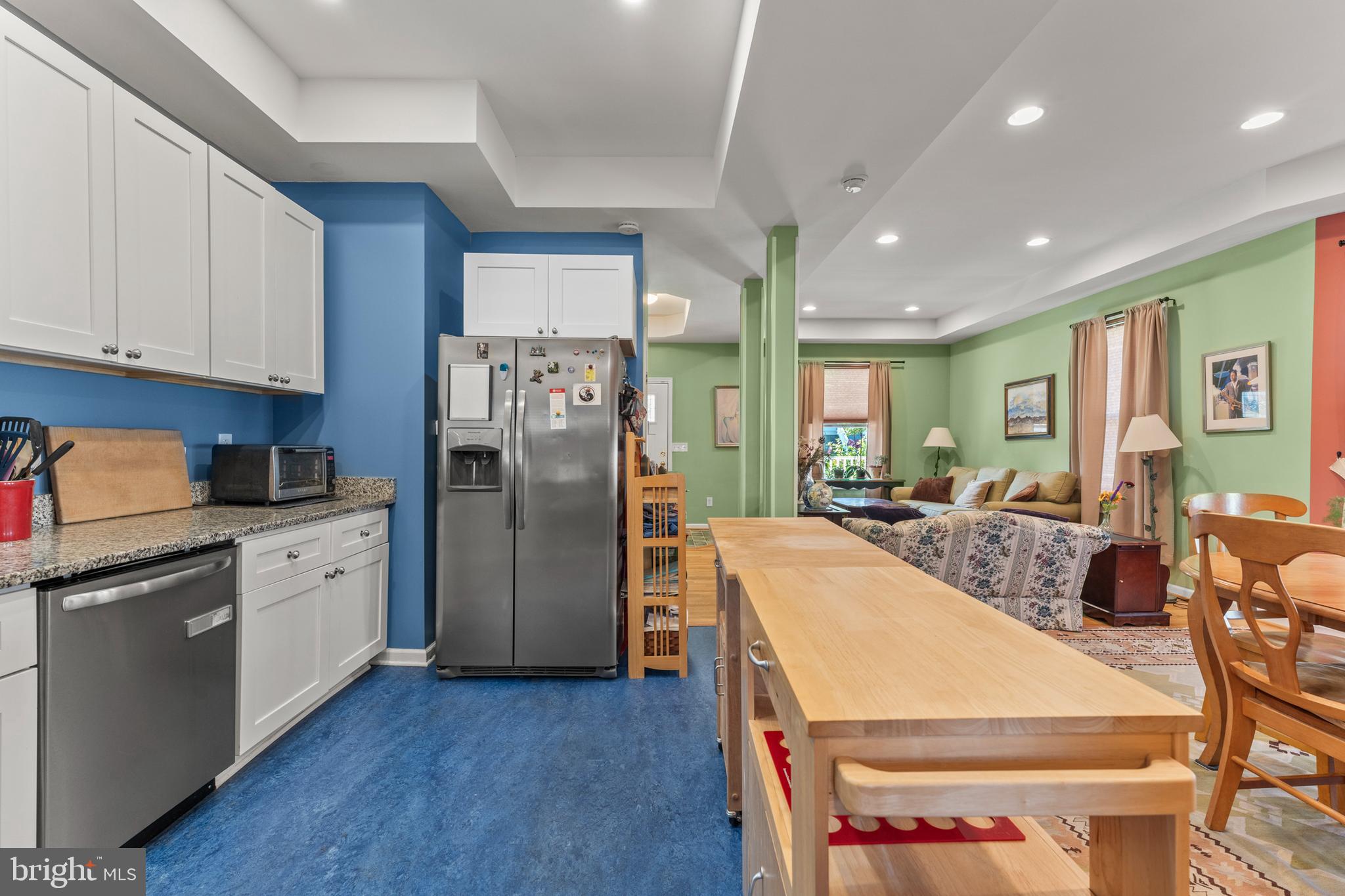 5012 Catalpha Road Baltimore, MD 21214 - Photo 11 of 44 a open kitchen with stainless steel appliances granite countertop a refrigerator a sink dishwasher a stove and white cabinets with wooden floor