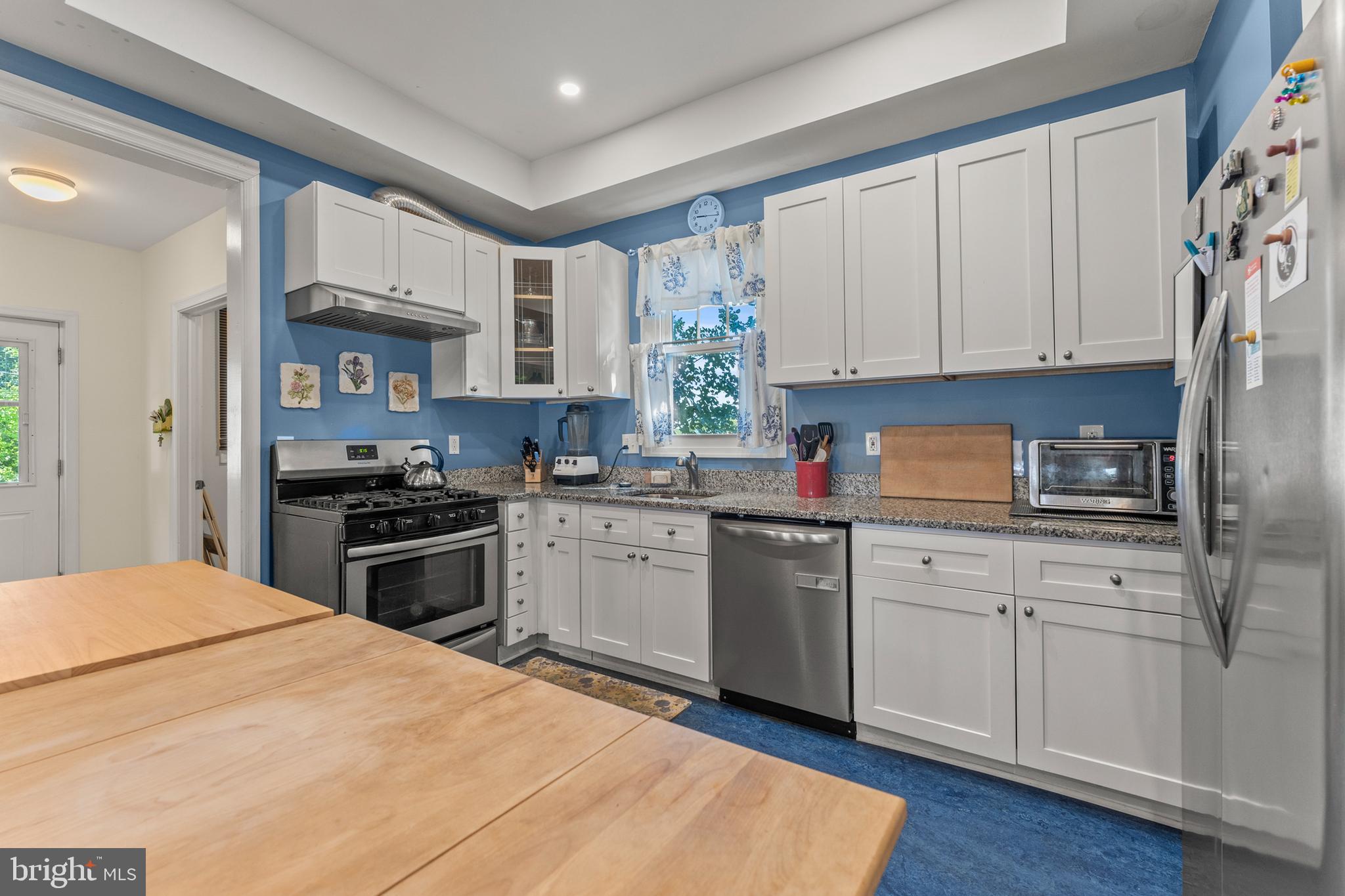 5012 Catalpha Road Baltimore, MD 21214 - Photo 12 of 44 a kitchen with stainless steel appliances granite countertop a stove a sink dishwasher and a refrigerator
