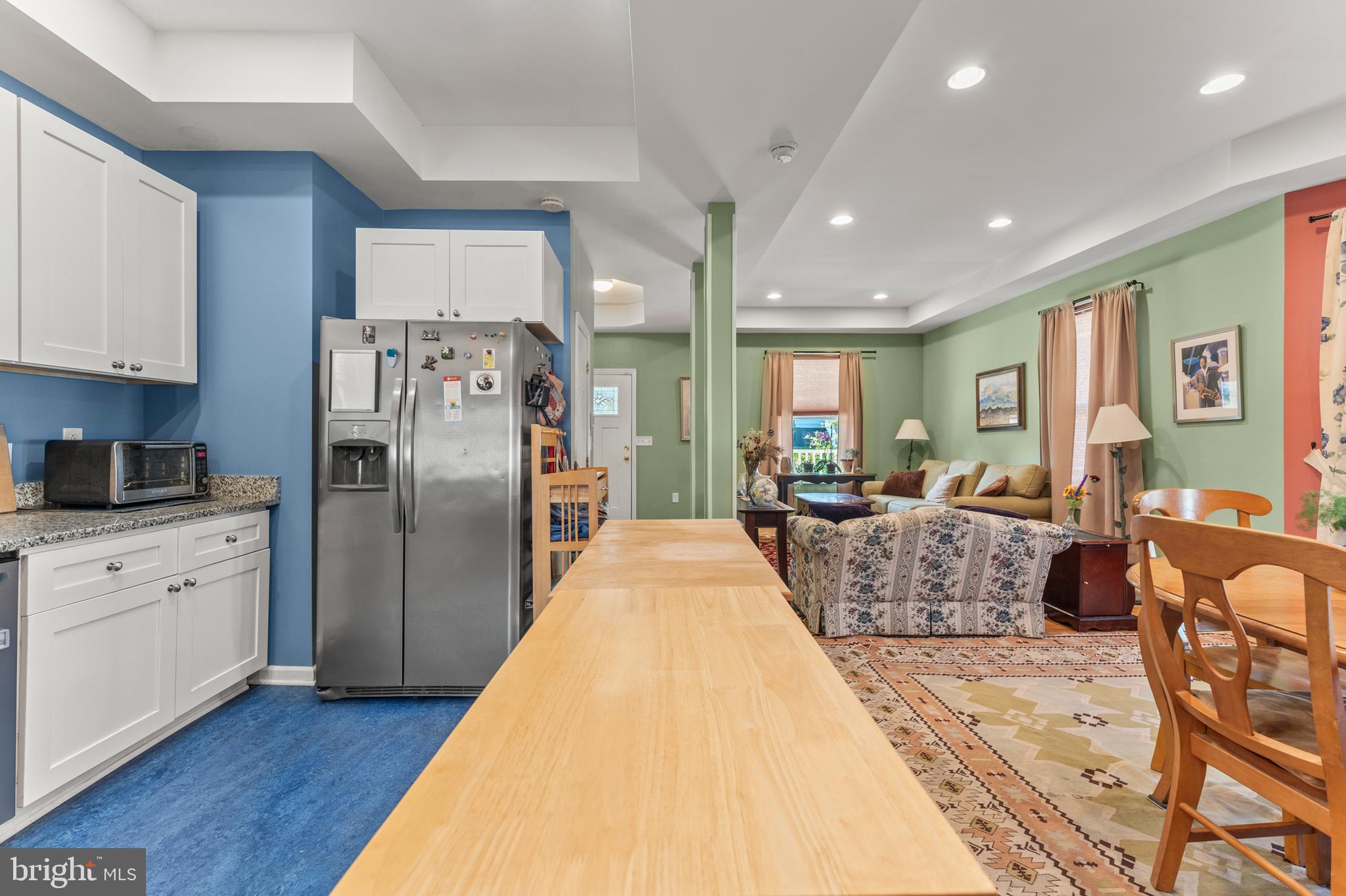 5012 Catalpha Road Baltimore, MD 21214 - Photo 14 of 44 a large center with stainless steel appliances kitchen island granite countertop a refrigerator and cabinets