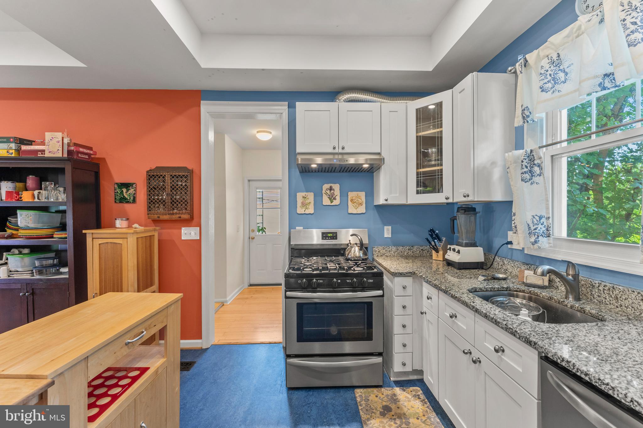 5012 Catalpha Road Baltimore, MD 21214 - Photo 16 of 44 a kitchen with granite countertop a stove and cabinets