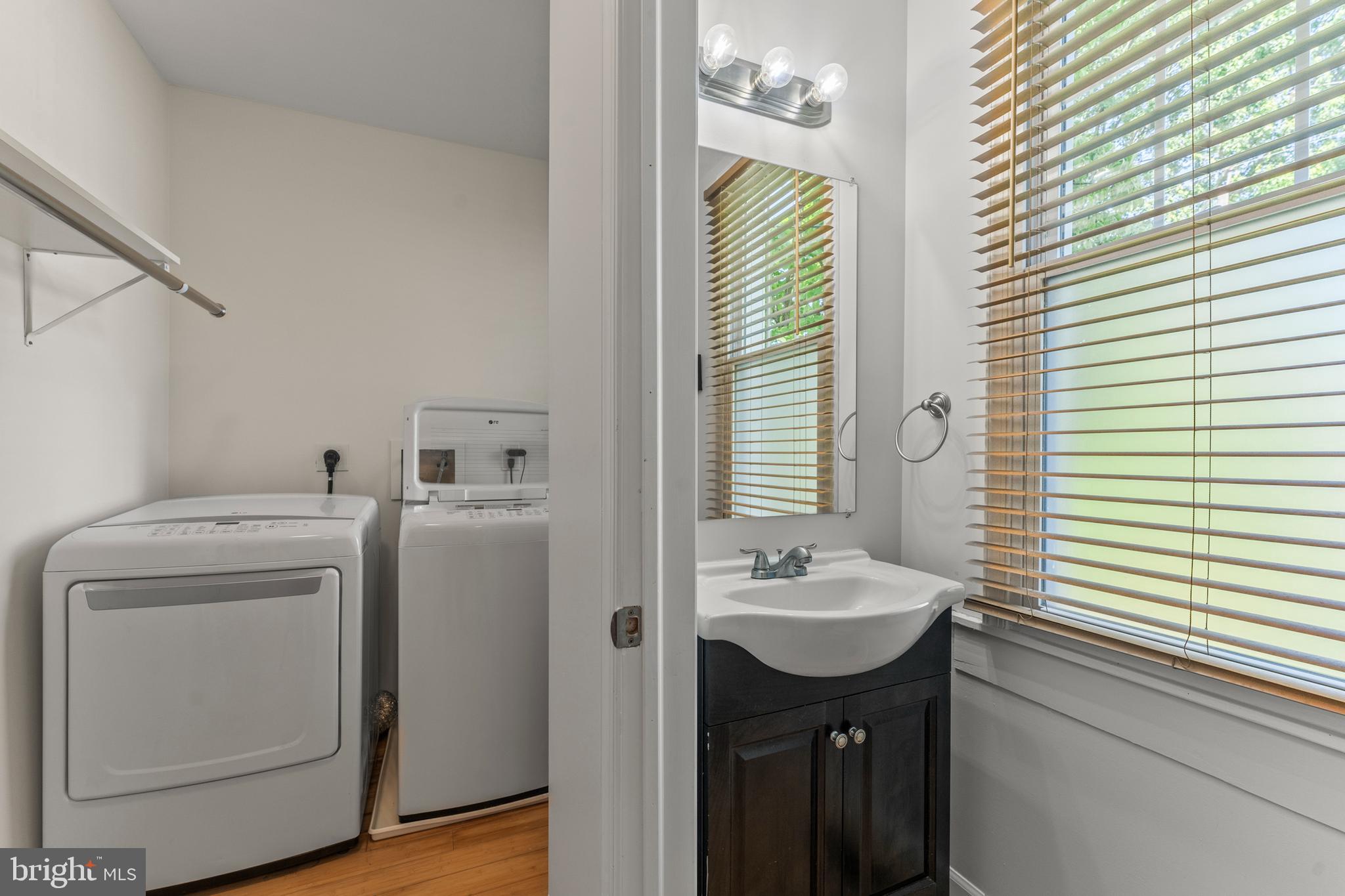 5012 Catalpha Road Baltimore, MD 21214 - Photo 19 of 44 a bathroom with a sink a washer and dryer