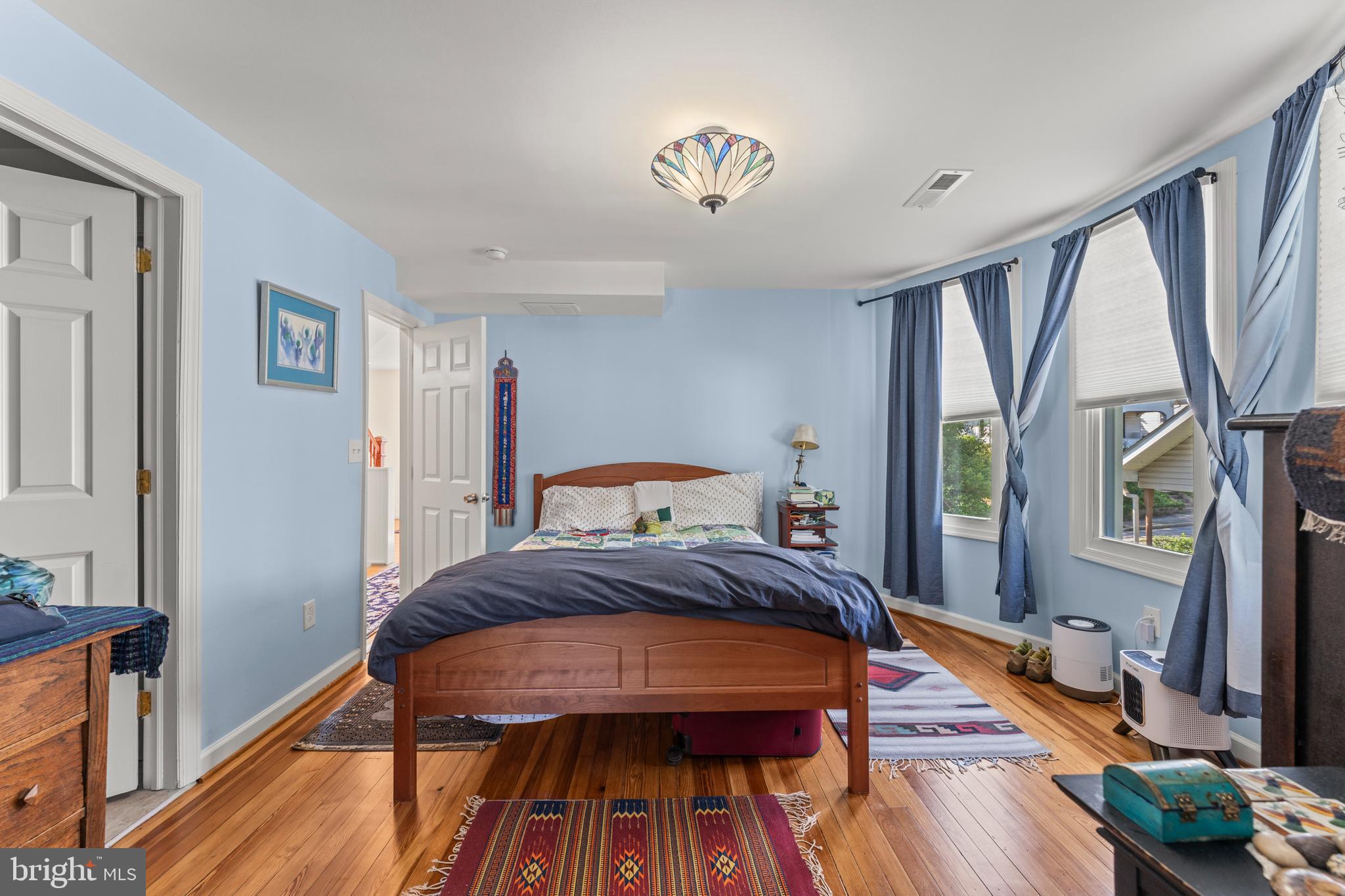 5012 Catalpha Road Baltimore, MD 21214 - Photo 21 of 44 a bedroom with a bed and a wooden floor