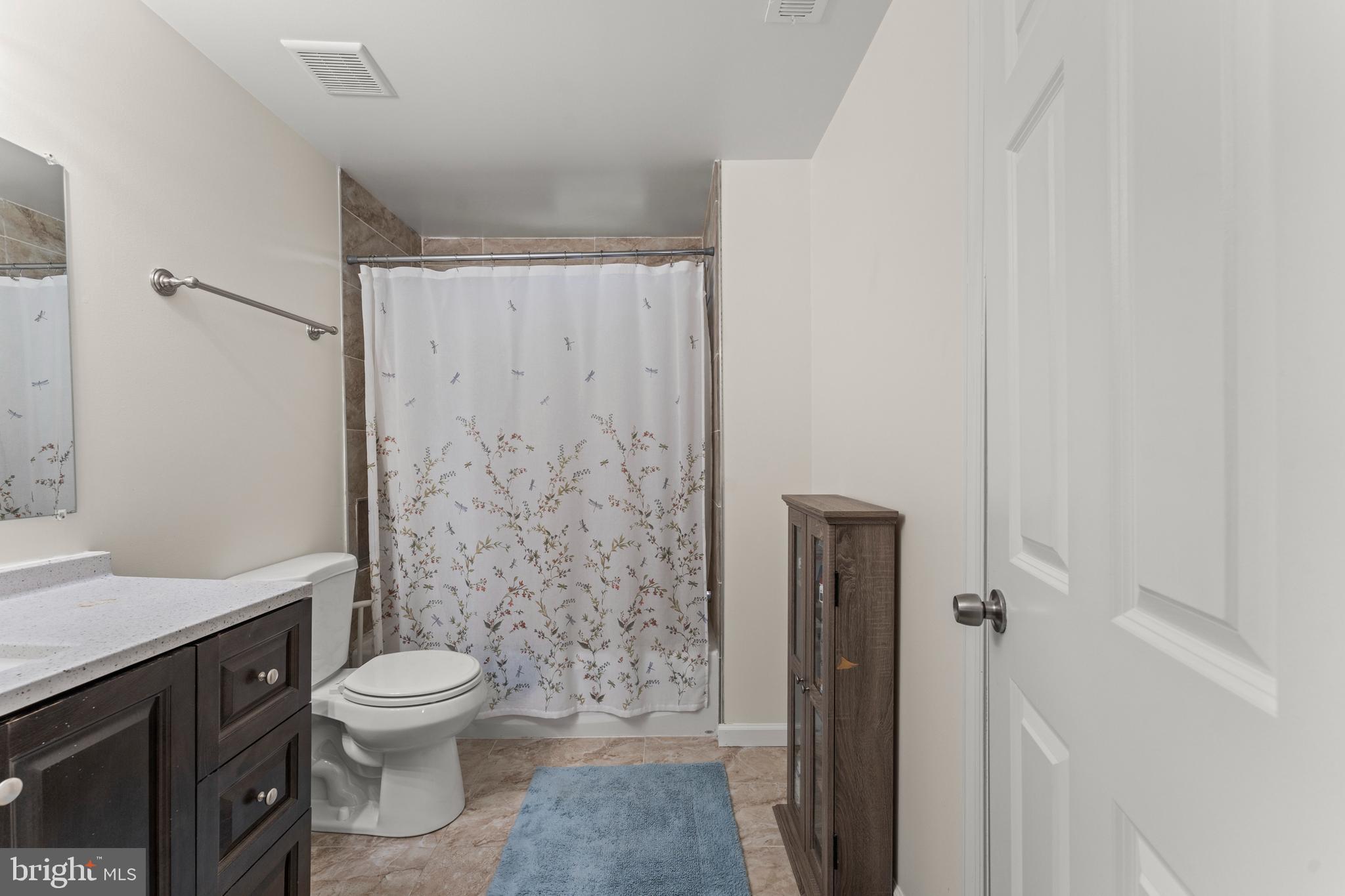 5012 Catalpha Road Baltimore, MD 21214 - Photo 25 of 44 a white toilet sitting next to a bathroom sink