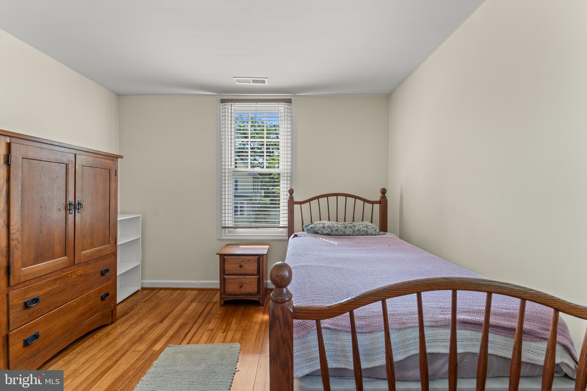 5012 Catalpha Road Baltimore, MD 21214 - Photo 29 of 44 a bedroom with a bed and wooden floor