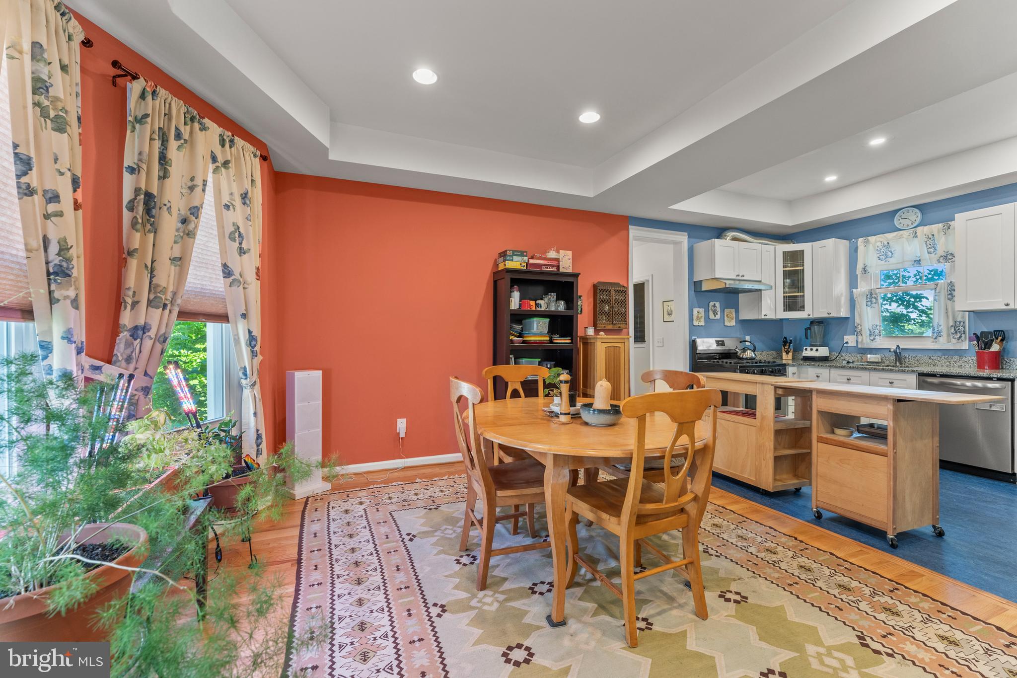 5012 Catalpha Road Baltimore, MD 21214 - Photo 9 of 44 a dining room with stainless steel appliances a dining table and chairs with wooden floor